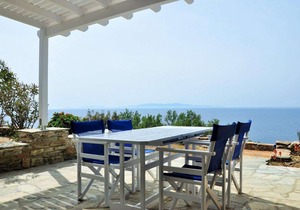 Windmill and houses by the sea / Stavros Bay