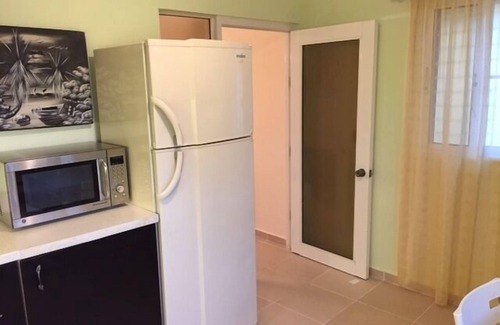 El Batey Apartment | Guest-Friendly 2-bedroom top-floor condo with pool in the center of Sosua