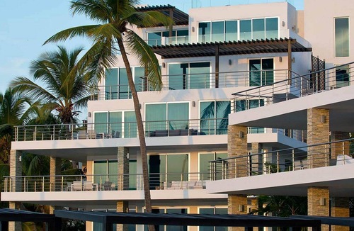 El Batey Apartment | 2BD beachfront condo in gated luxury residence, gym/pool, near everything