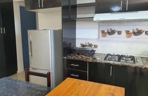 Suva Apartment | Master Bedroom with shared kitchen and living room