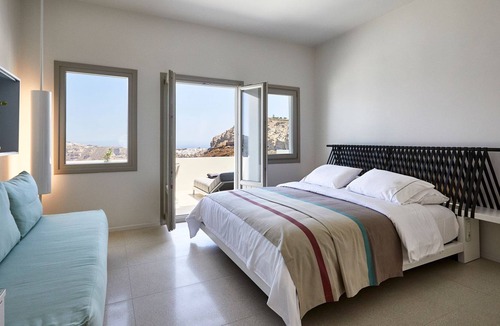 Megalochori Villa | R 321 Rubi Suite Santorini patio, with exterior Jacuzzi mini pool, overlooking view of Caldera Incl