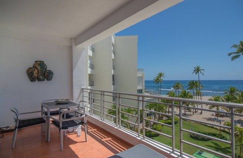 Juan Dolio Apartment | Trendy Beach Scene at a Harmony Beachfront Condo in Costa del Sol