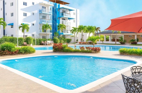 Punal Condo | Unwind in this modern 3-bedroom apartment just 7 minutes from STI Airport and El Monumento. Sleeps up to 10 guests, features a fully equipped kitchen, A/C in every room, smart TV, washer/dryer, and Wi-Fi. Enjoy resort-style amenities including a gym,