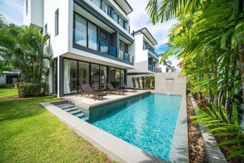 Modern minimalist style luxury villa with private pool located in a high-end resort area adjacent to Laguna Park Golf Course