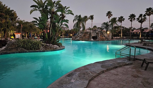 Relax on the oversized lanai featuring an outdoor kitchen and mid-water view. in Naples