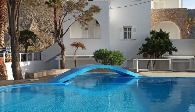 Relaxing environment under trees with a swimming pool, a pool bar.