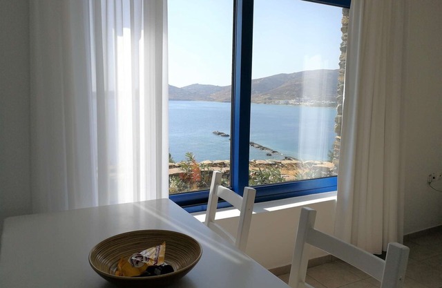 Windmill and houses by the sea / Stavros Bay
